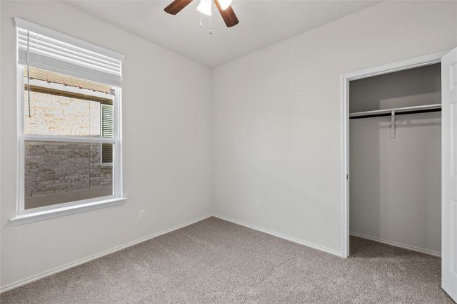 Unfurnished bedroom with ceiling fan, a closet, and carpet floors | Image 25