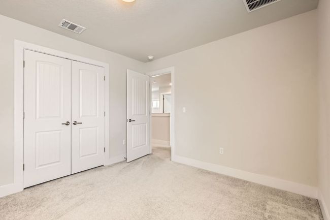 Unfurnished bedroom featuring light carpet and a closet | Image 22