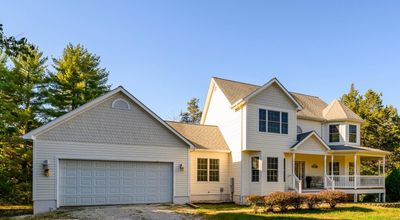 View of front of home featuring a porch and a garage | Image 2