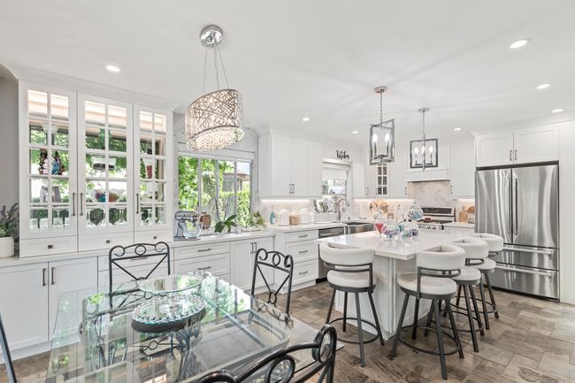 Dining space featuring a chandelier, recessed lighting, and stone finish flooring | Image 17