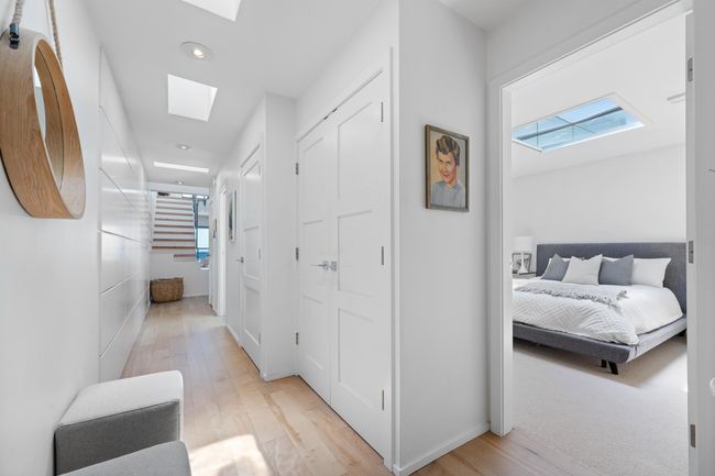 Hall with a skylight, light wood-style flooring, recessed lighting, and stairway | Image 20