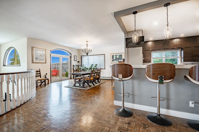 Kitchen with a breakfast bar, plenty of natural light, light countertops, and pendant lighting | Image 8