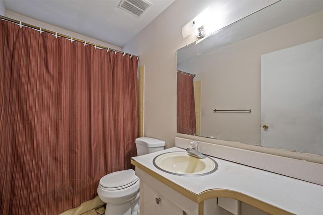 Bathroom featuring toilet, visible vents, and vanity | Image 21