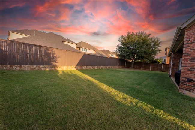Yard at dusk with a fenced backyard | Image 37