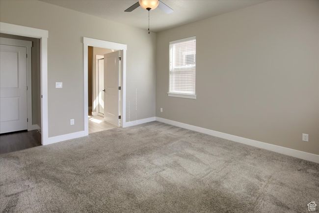 Unfurnished bedroom with light carpet, baseboards, and a ceiling fan | Image 14
