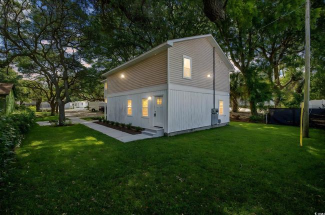 View of side of property featuring entry steps and a yard | Image 36
