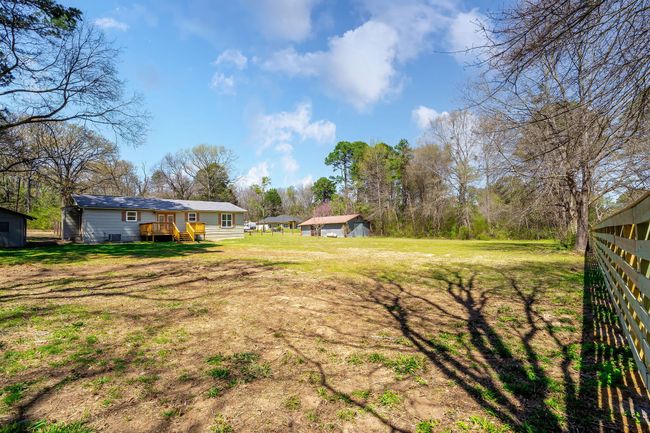View of yard with fence and an outbuilding | Image 11