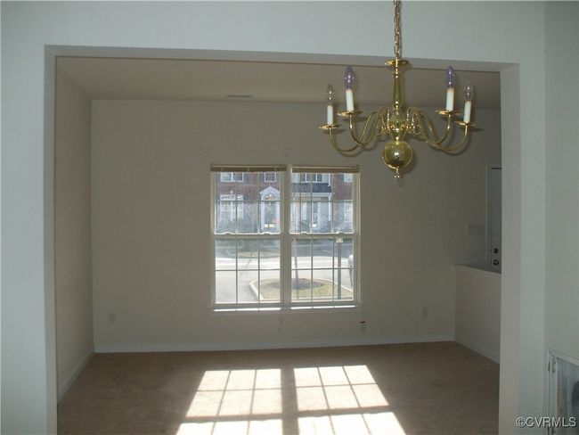 Carpeted empty room with a chandelier | Image 5