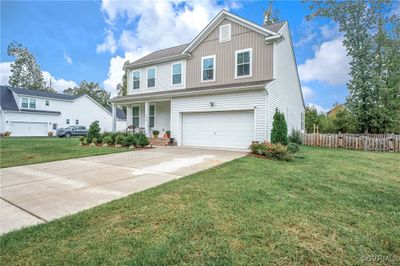 View of front of house featuring a front yard and a garage | Image 3