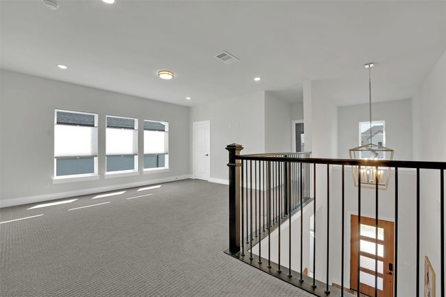 Spare room featuring baseboards, carpet flooring, visible vents, and plenty of natural light | Image 32