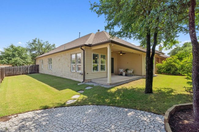 The covered patio is perfect for grilling and relaxation. | Image 32