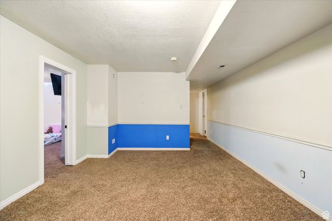 Carpeted empty room with baseboards and a textured ceiling | Image 23