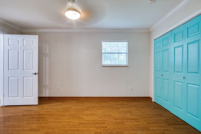 Unfurnished bedroom featuring ornamental molding, a closet, light wood-type flooring, and a ceiling fan | Image 16