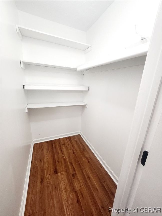 Walk in closet featuring dark hardwood / wood-style flooring | Image 12