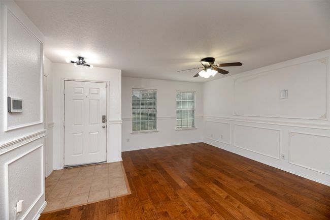 Foyer featuring a decorative wall, ceiling fan, and engineered wood floors | Image 9