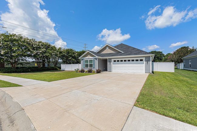 Ranch-style house with a garage, driveway, and roof with shingles | Image 29
