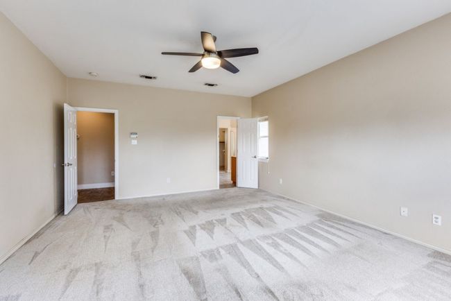 Spare room with visible vents, a ceiling fan, and light carpet | Image 19