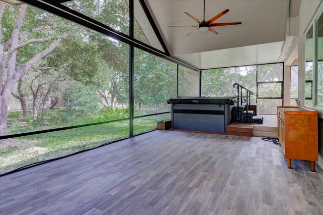 Sunroom featuring a swim/spa, ceiling fan, and vaulted ceiling | Image 32