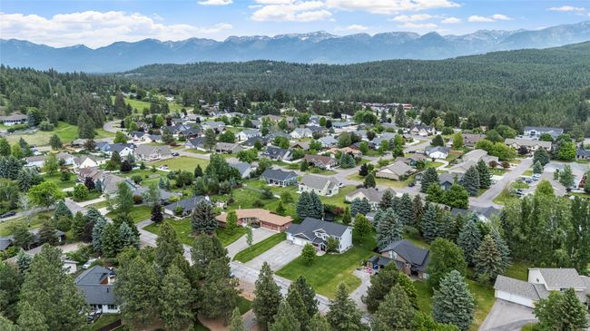 Bird's eye view of a heavily wooded area and mountains | Image 16