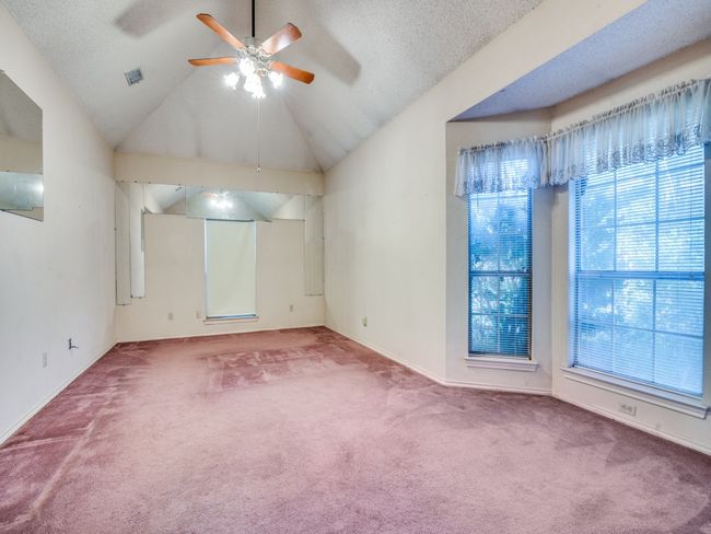 Spare room with carpet flooring, a ceiling fan, lofted ceiling, and baseboards | Image 9