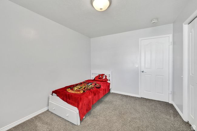 Carpeted bedroom featuring baseboards | Image 21