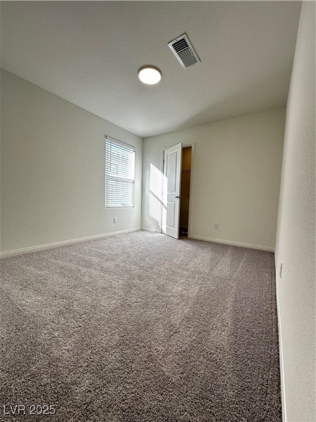 Empty room with carpet floors, visible vents, and baseboards | Image 15