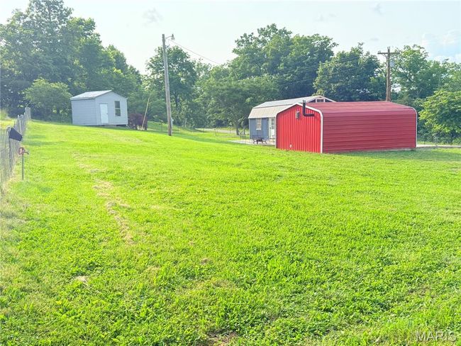 View of yard with a pole building | Image 49
