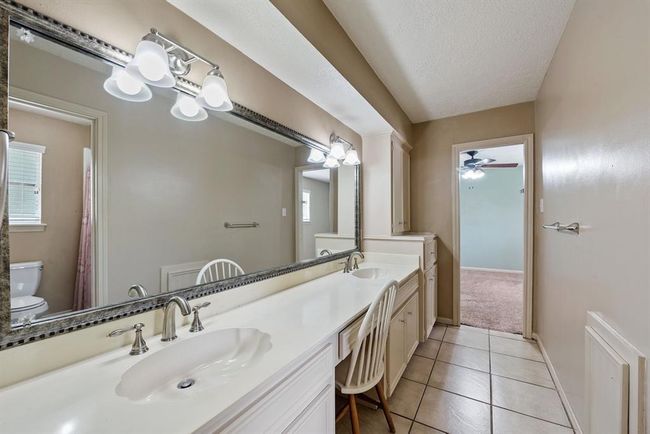 Bedroom has private accees to bathroom with double sinks and vanity area. | Image 23