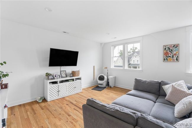 Living area with light wood-type flooring and baseboards | Image 23