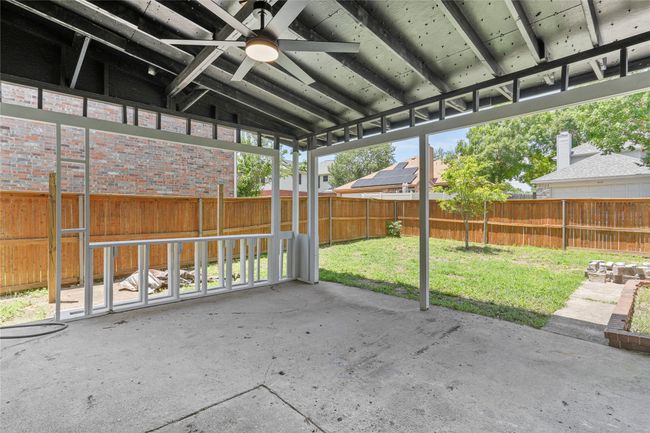 Unfurnished sunroom featuring a ceiling fan and lofted ceiling | Image 27