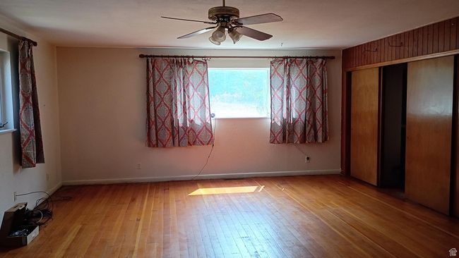 Family room featuring light wood-style floors, ceiling fan, and a closet | Image 32