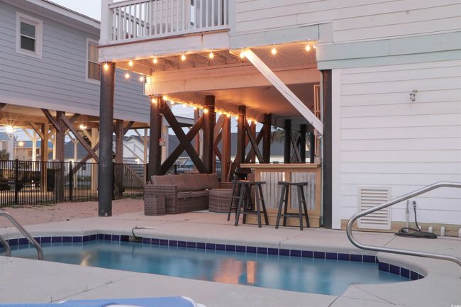 View of swimming pool with a fenced in pool, a patio area, fence, and an outdoor living space | Image 33