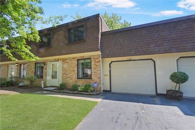 View of front facade featuring a front yard and a garage | Image 1