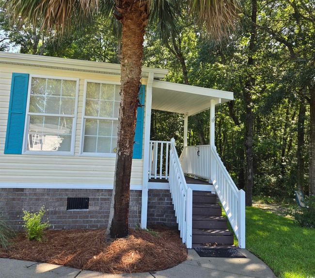 Property entrance with crawl space and covered porch | Image 8