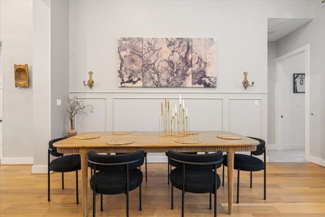 Dining area with a decorative wall, light wood-style floors, a wainscoted wall, baseboards, and breakfast area | Image 11