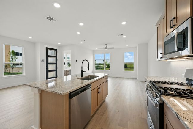 Featuring a kitchen open to the dining and family rooms, the chef will never be left out of the party in this dream home! | Image 11