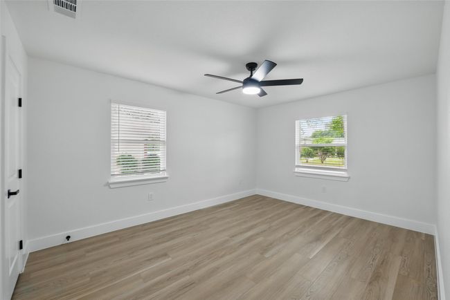 Unfurnished room featuring light wood-type flooring, baseboards, and a ceiling fan | Image 24