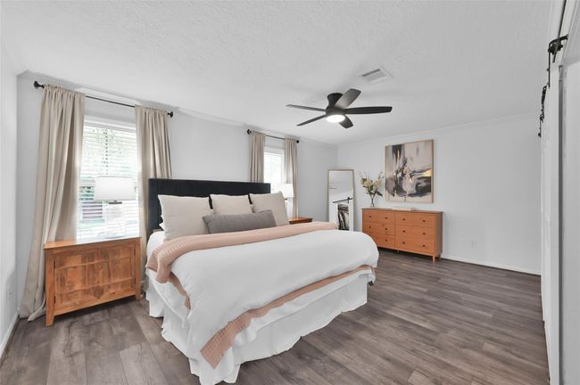 The Primary Suite has plenty of room for King-sized furniture sets and stays bright with two windows covered with faux wood blinds. | Image 14