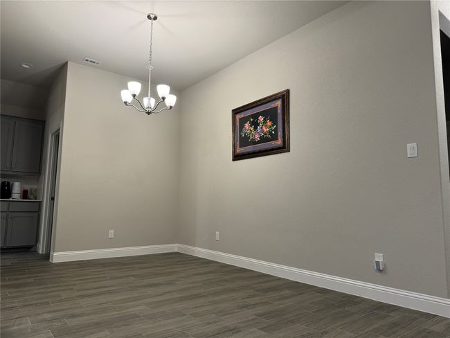 Unfurnished dining area with dark hardwood / wood-style floors and a chandelier | Image 11