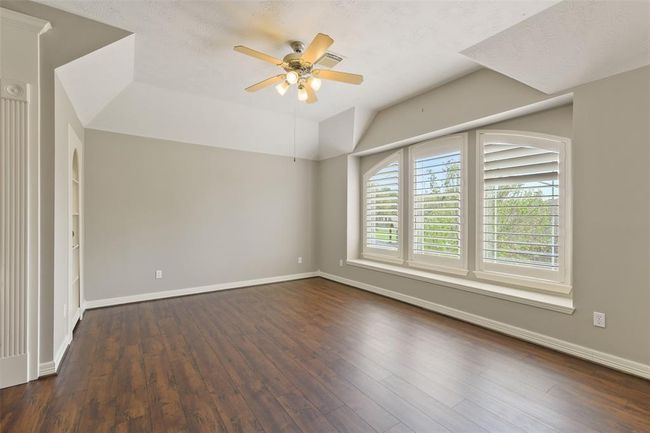 Upstairs Gameroom with a window seat, Plantation shutters, updated flooring, built-ins and hidden storage. | Image 27