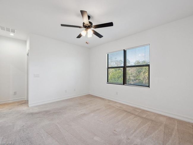 Spare room with light colored carpet and ceiling fan | Image 17