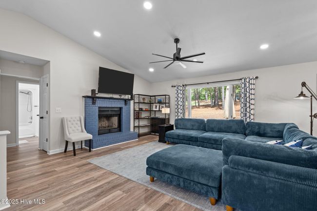 living room with vaulted ceiling and fireplace | Image 4