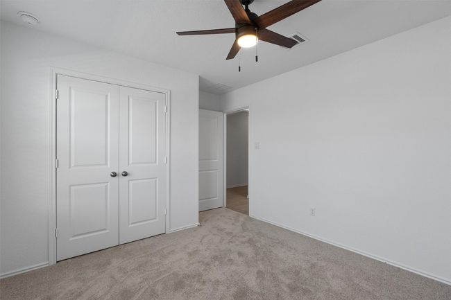 Unfurnished bedroom with carpet, a closet, and ceiling fan | Image 18