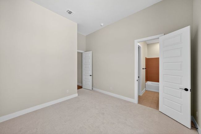 Unfurnished bedroom featuring light colored carpet and baseboards | Image 19
