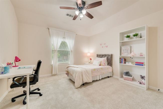 Carpeted bedroom with a desk, baseboards, and ceiling fan | Image 26