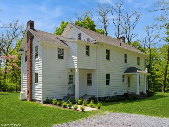 View of home's exterior with a chimney, roof with shingles, a yard, and entry steps | Image 7