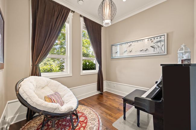 Sitting room featuring healthy amount of natural light, dark wood-style floors, and ornamental molding | Image 11