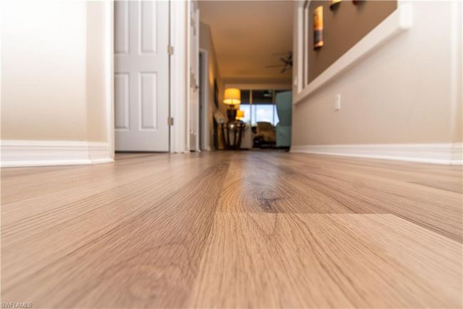 Easy care light colored luxury vinyl plank flooring graces the entire condo. | Image 28