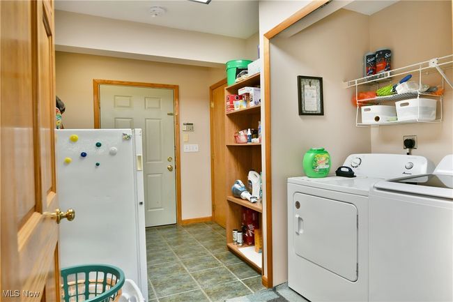 Clothes washing area featuring independent washer and dryer and baseboards | Image 34