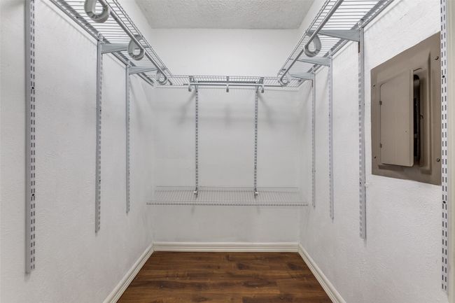 Walk in closet with wood finished floors and electric panel | Image 17